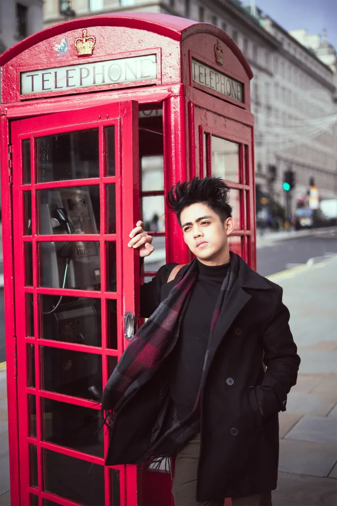 Portrait beside a red London telephone box