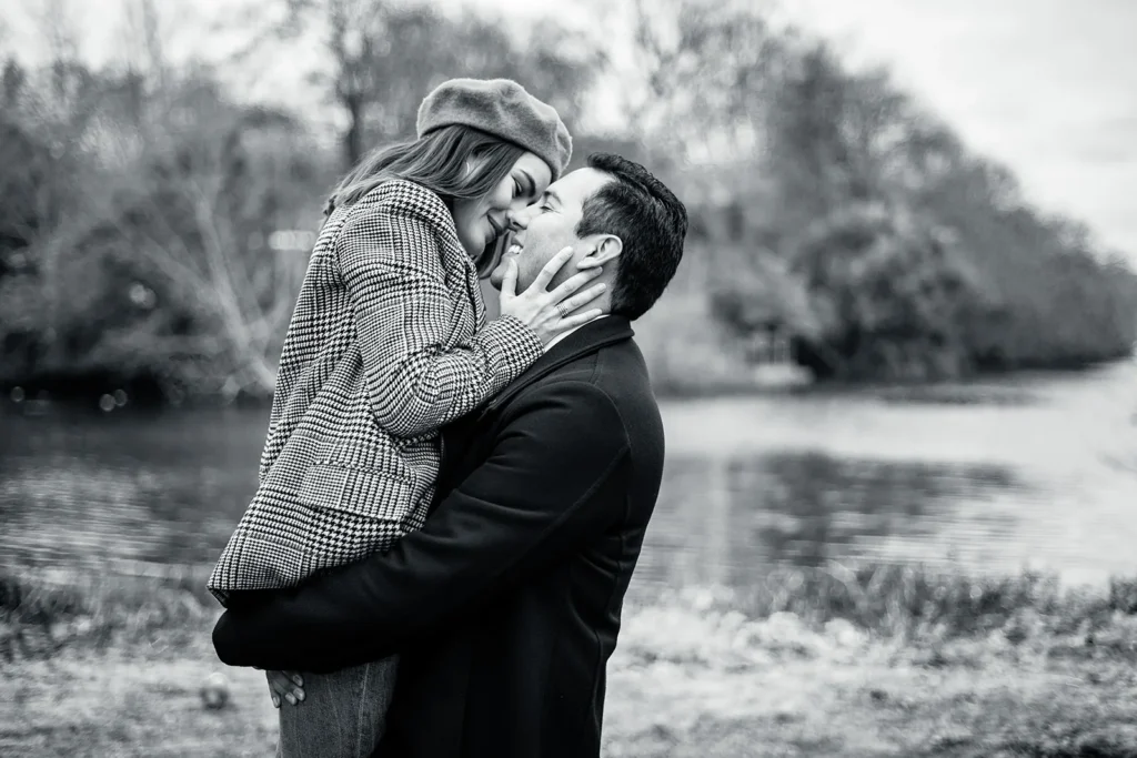 Couple embracing beside a lake in a London park